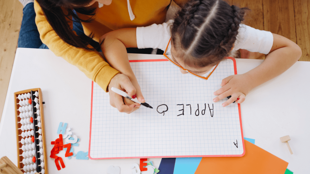 A parent and child working together at a table