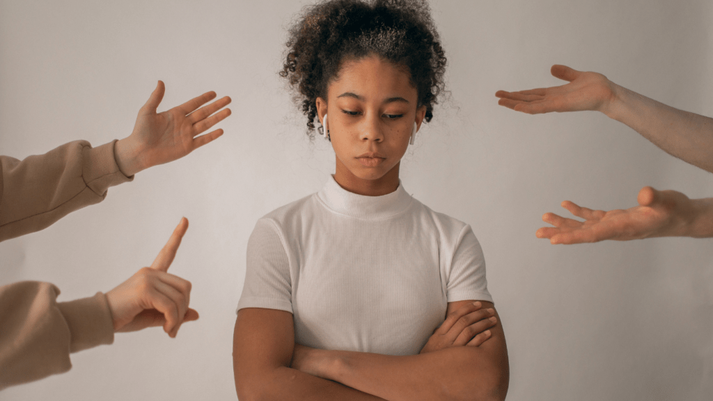 a person standing in front of a group of people with their hands outstretched