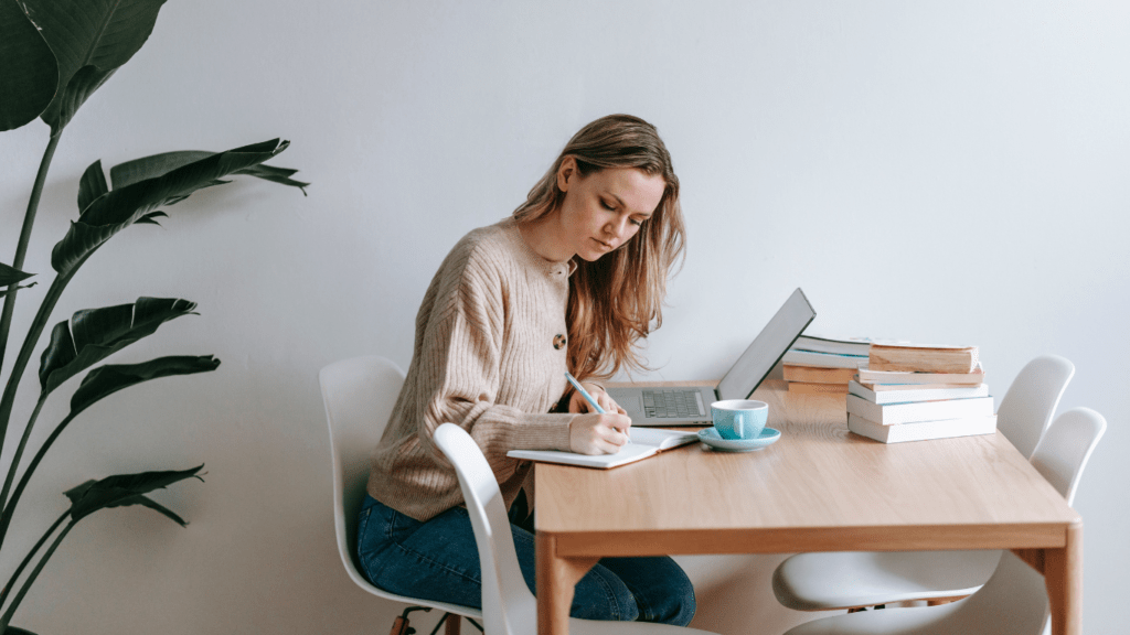 a person writing on a piece of paper