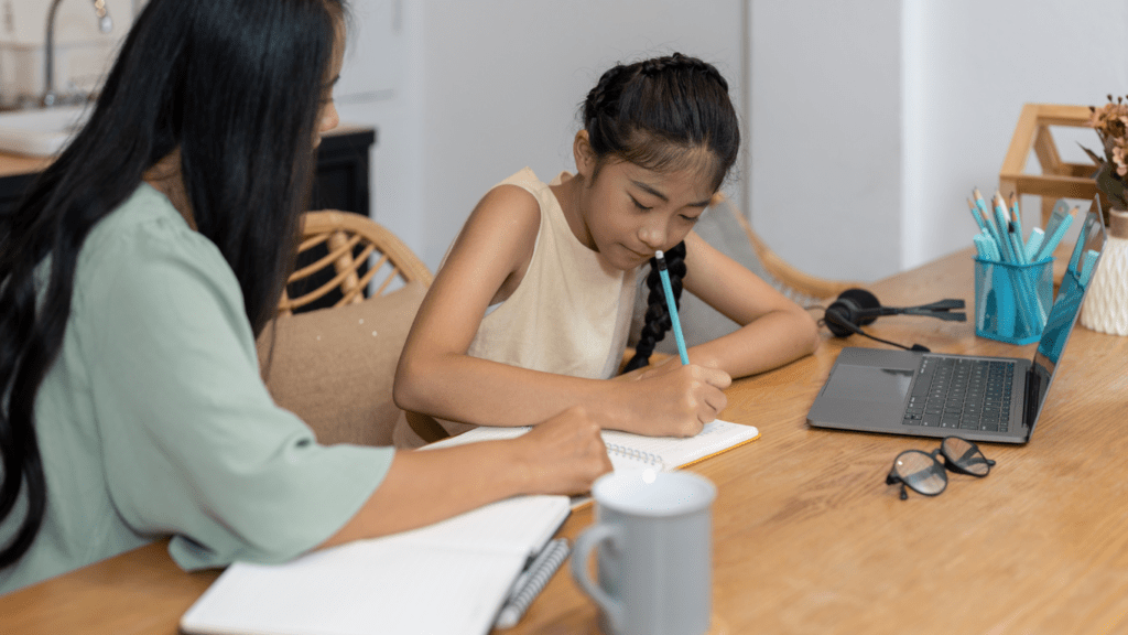 A parent and child working together at a table