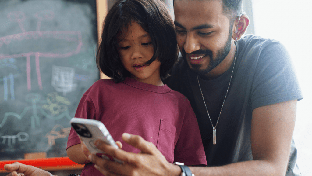 Two individuals looking at a cell phone