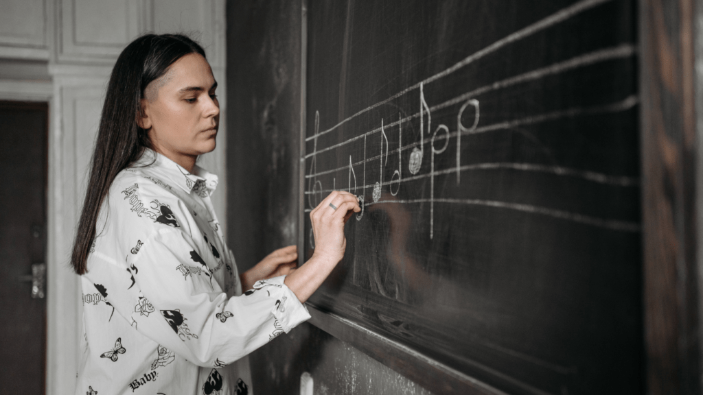 A person is writing on a blackboard