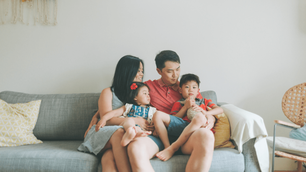 a family sitting on a couch