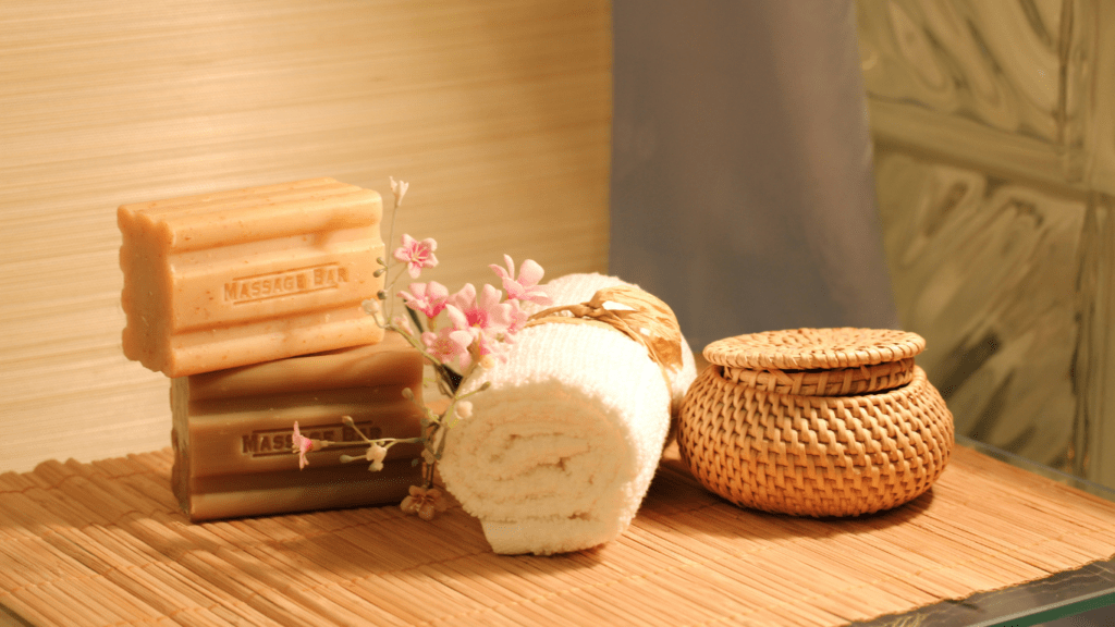 soap and towels on a wooden tray in a bathroom