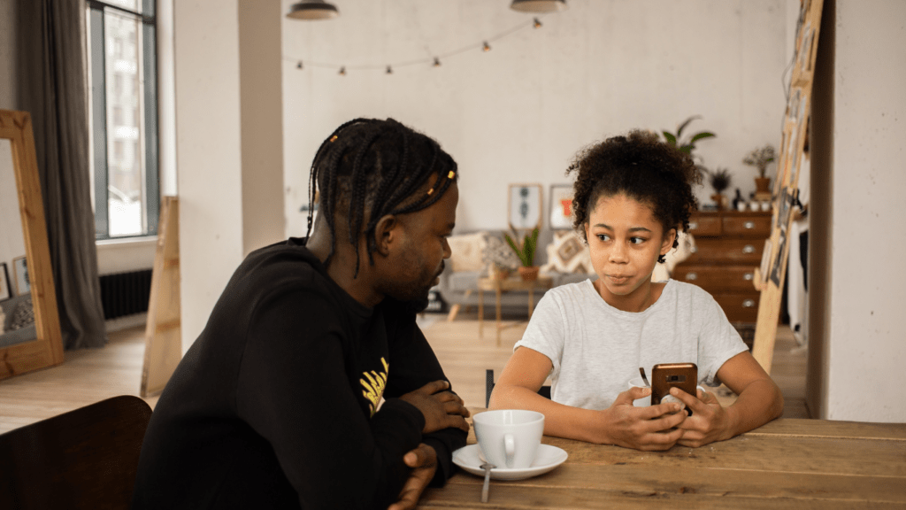 Two individuals looking at a cell phone