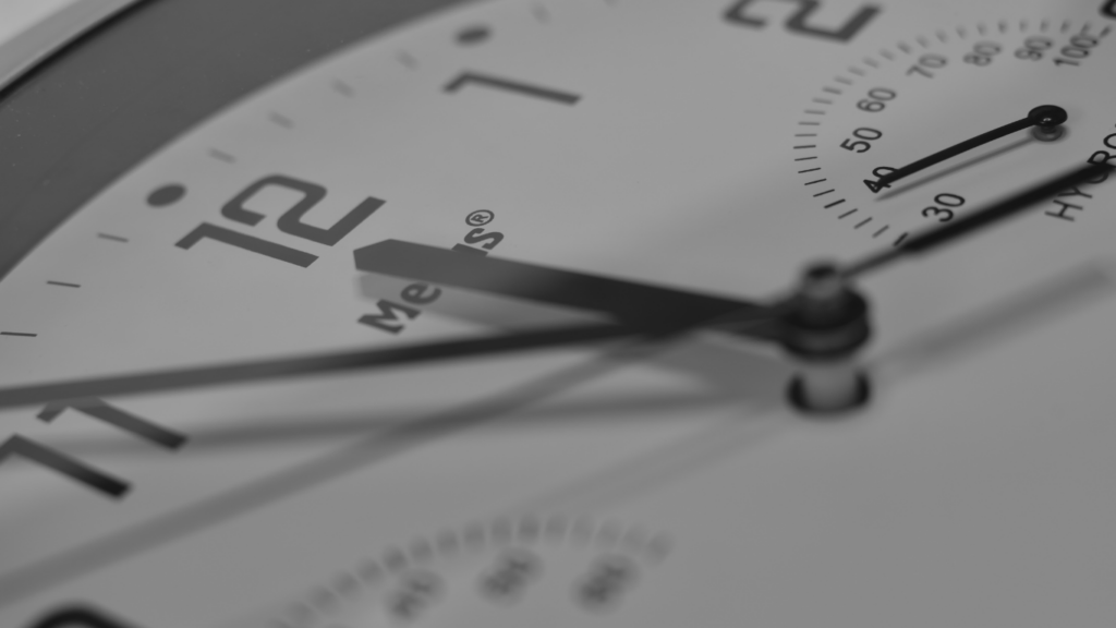 a black and white photo of an alarm clock