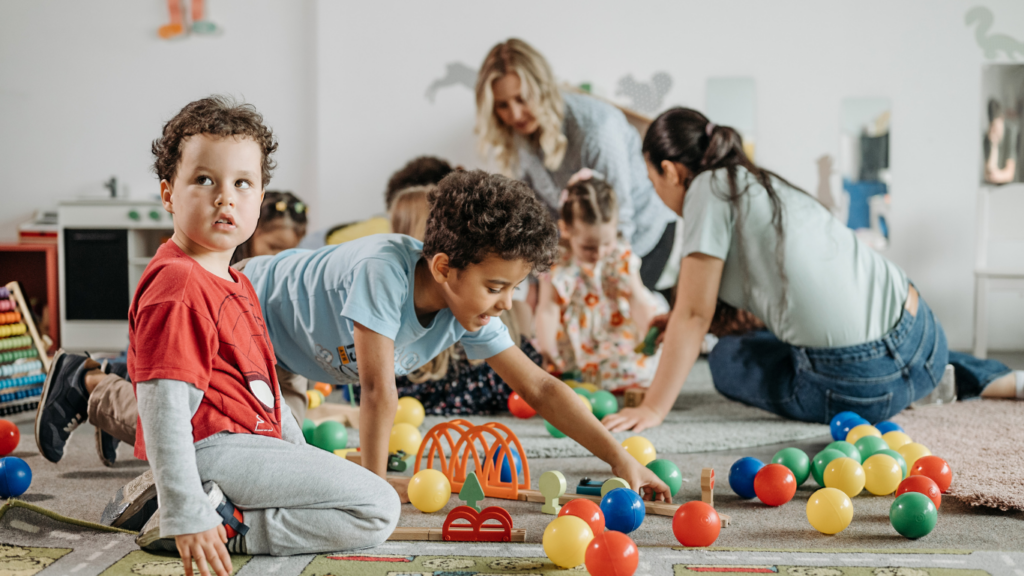 a group of children playing with toys in a room