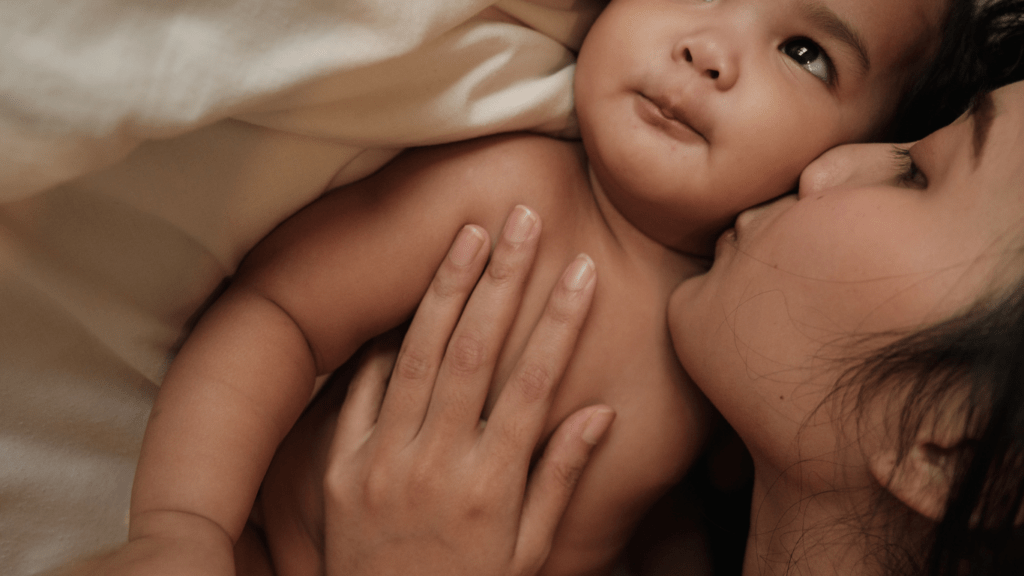 a person kissing a baby