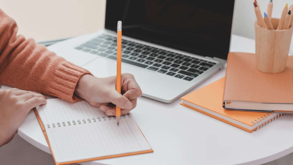 a person writing on a piece of paper