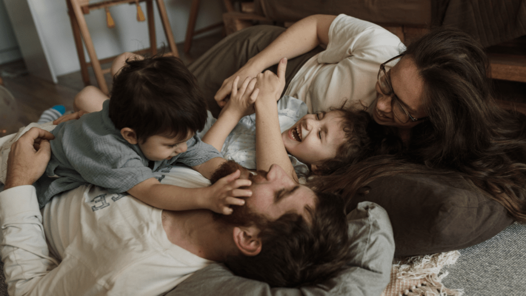 an image of a family laying on the floor together