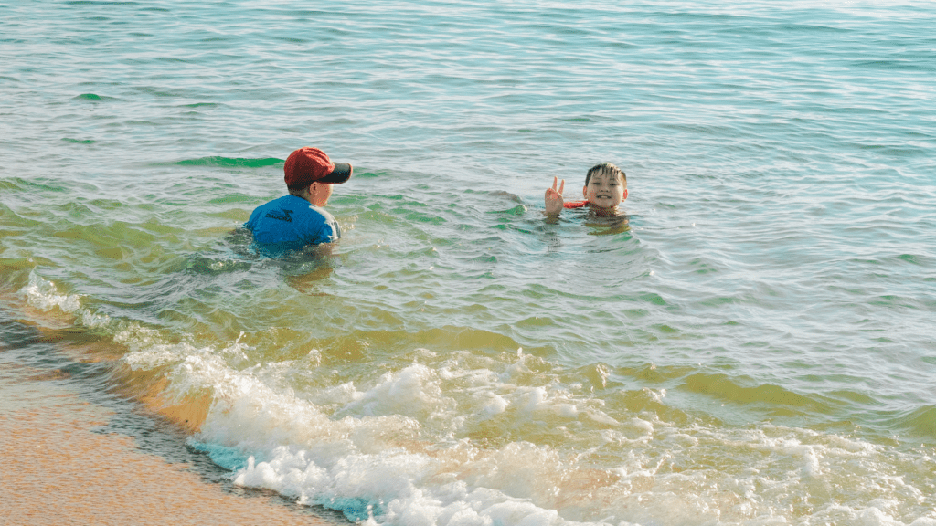 people swimming at the beach